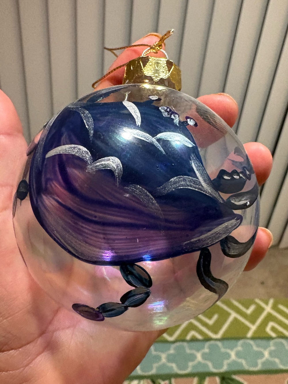 clear blown-glass Christmas ornament
with a hand-painted design